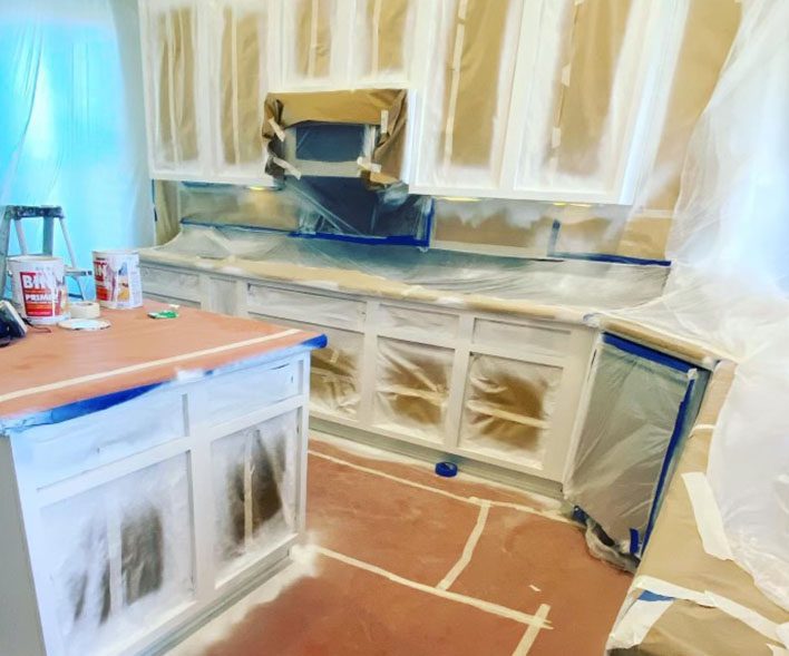 Kitchen cabinets prepared for painting renovation.